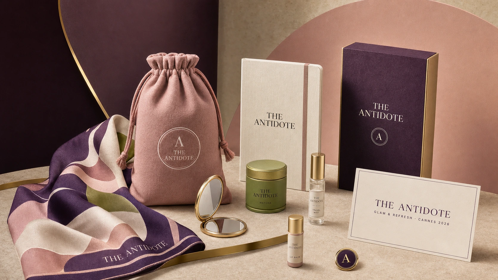 A colorful luxury Antidote gifting collection with a blush pouch, silk scarf, notebook, matcha tin, mirror, and beauty items.